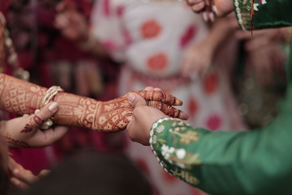 Bride and groom exchanging rings, hands in close up