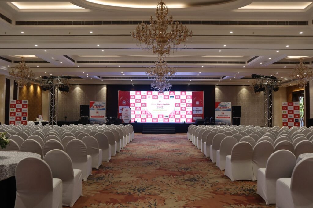 Conference seating facing an LED stage at a corporate event