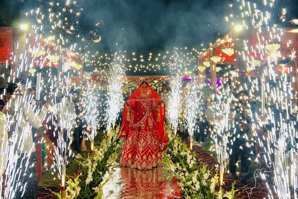 Bride entering under sparkler fountains at a Lucknow wedding